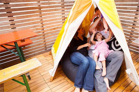 summer family backyard - Family playing in tent Stock Photo - Premium Royalty-Free, Code: 614-06896704