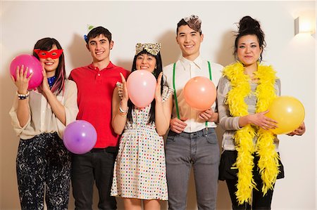 feather boa - Friends at a party with balloons, studio shot Stock Photo - Premium Royalty-Free, Code: 614-06896882