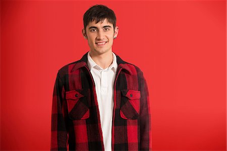 red interiors - Portrait of young man wearing checked shirt Stock Photo - Premium Royalty-Free, Code: 614-06896903