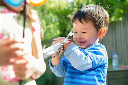 simsearch:614-06896931,k - Male toddler in garden with toy airplane Photographie de stock - Premium Libres de Droits, Code: 614-06896992
