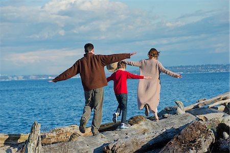 simsearch:614-06897023,k - Back view of family walking along tree trunk at coast Stock Photo - Premium Royalty-Free, Code: 614-06897030
