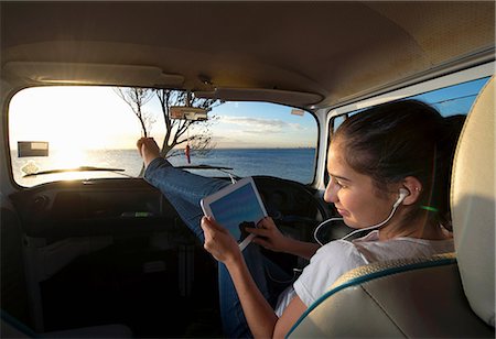 Young woman in camper van using digital tablet Stock Photo - Premium Royalty-Free, Code: 614-06897278