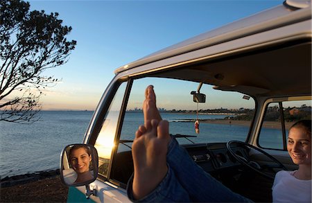 Young woman with feet up on camper van window Stock Photo - Premium Royalty-Free, Code: 614-06897280