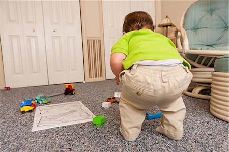 Young male toddler playing with toys Stock Photo - Premium Royalty-Free, Code: 614-06897445