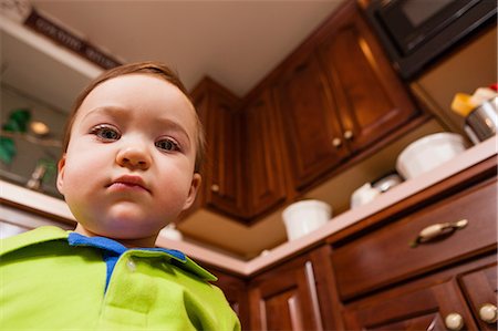 simsearch:614-06897440,k - Close up portrait of young male toddler in kitchen Stock Photo - Premium Royalty-Free, Code: 614-06897448