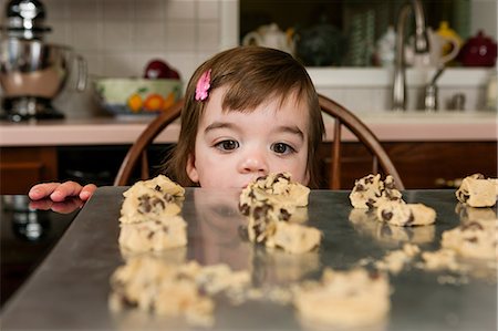 simsearch:614-06897440,k - Close up portrait of young female toddler looking at currant cakes Stock Photo - Premium Royalty-Free, Code: 614-06897440