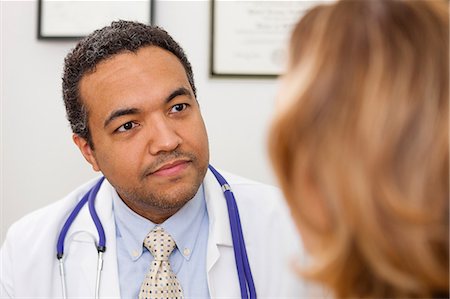 doctor and patient male ethnic - Mature doctor listening to patient Stock Photo - Premium Royalty-Free, Code: 614-06897480