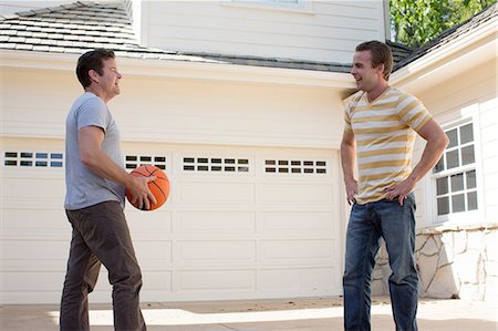 Father holding basketball with adult son Stock Photo - Premium Royalty-Free, Code: 614-06897588