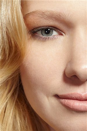 eyebrow - Close-up portrait of blonde woman looking at camera Stock Photo - Premium Royalty-Free, Code: 614-06897686