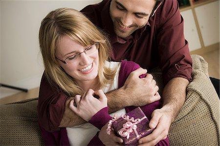 Young man giving woman gift Stock Photo - Premium Royalty-Free, Code: 614-06897779