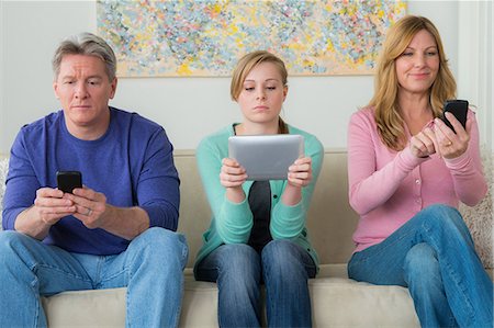 daughter with dad in home - Family with teenage girl using communication devices Stock Photo - Premium Royalty-Free, Code: 614-06897820