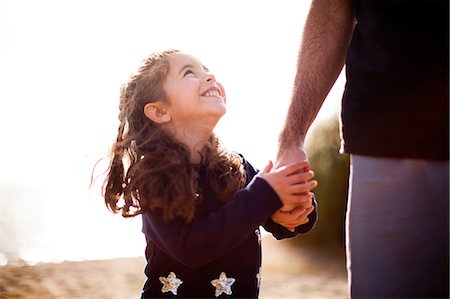 family holding hands beach - Girl holding father's hand, looking up Stock Photo - Premium Royalty-Free, Code: 614-06898047