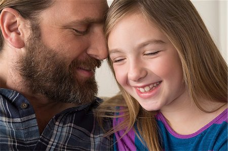 spinning top - Father leaning face on daughter's head Stock Photo - Premium Royalty-Free, Code: 614-06898277