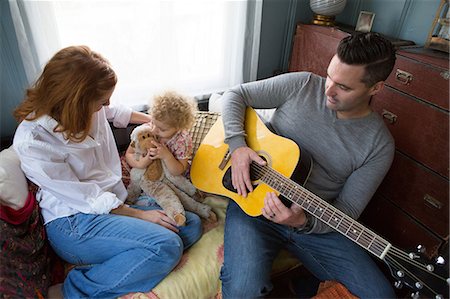 redhead baby girl - Husband & wife entertaining child Stock Photo - Premium Royalty-Free, Code: 614-06898404