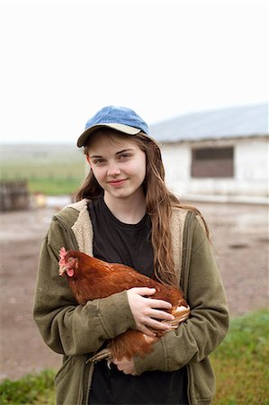 success smile outdoors - Girl carrying hen Stock Photo - Premium Royalty-Free, Code: 614-06898458