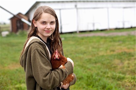 Girl carrying hen Stock Photo - Premium Royalty-Free, Code: 614-06898459