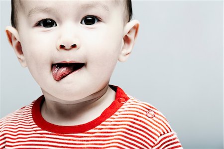 Portrait of baby boy wearing striped top looking at camera Stock Photo - Premium Royalty-Free, Code: 614-06974723