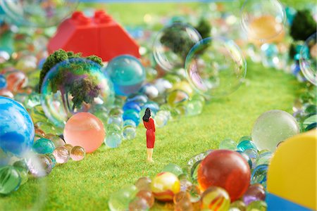 surreal - Figurines on pretend grass with marbles Stock Photo - Premium Royalty-Free, Code: 614-06974866