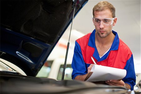 Car mechanic at work in service bay Stock Photo - Premium Royalty-Free, Code: 614-06973673