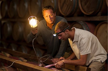 Checking wine aging in barrels Stock Photo - Premium Royalty-Free, Code: 614-06973686