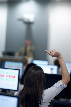 Student with arm raised in lecture Stock Photo - Premium Royalty-Free, Code: 614-06973857