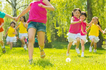 Children running on grass Stock Photo - Premium Royalty-Free, Code: 614-07031198