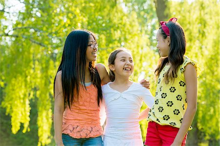 simsearch:614-03469543,k - Three girls in park with arms around each other Stock Photo - Premium Royalty-Free, Code: 614-07031223