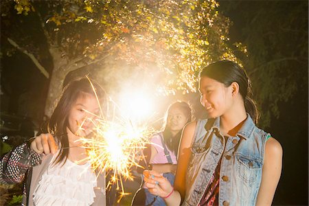 Girl with sparkler at night Stock Photo - Premium Royalty-Free, Code: 614-07031250