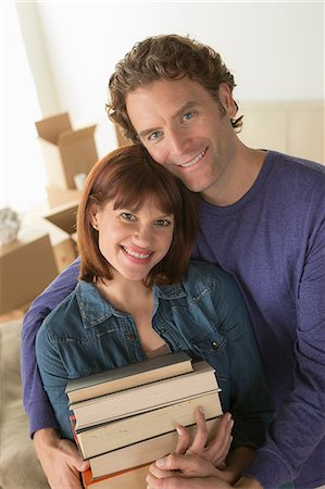 denim shirt - Couple holding pile of books Foto de stock - Sin royalties Premium, Código: 614-07031343