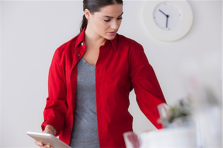 red interiors - Female office worker holding digital tablet Stock Photo - Premium Royalty-Free, Code: 614-07031362