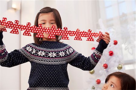 Girl holding Christmas decorations Stock Photo - Premium Royalty-Free, Code: 614-07031474