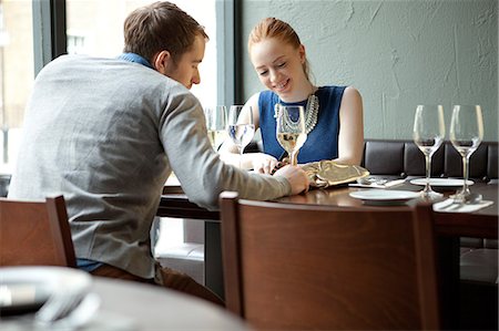 people sitting in restaurants - Young couple in restaurant Stock Photo - Premium Royalty-Free, Code: 614-07031523