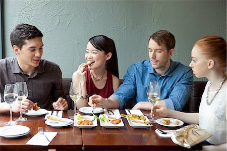 people restaurant not eye contact - Four friends eating food in restaurant Stock Photo - Premium Royalty-Free, Code: 614-07031533