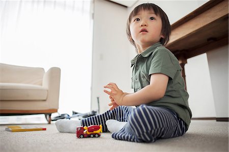 Boy playing with toy car, portrait Stock Photo - Premium Royalty-Free, Code: 614-07031615