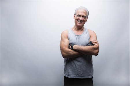 fits - Senior man in sports clothing with arms crossed, portrait Stock Photo - Premium Royalty-Free, Code: 614-07031736