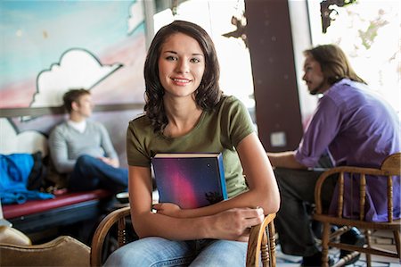 revising - Teenager holding book in cafe Stock Photo - Premium Royalty-Free, Code: 614-07031970
