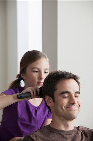 pampered - Daughter brushing father's hair Stock Photo - Premium Royalty-Free, Code: 614-07146325