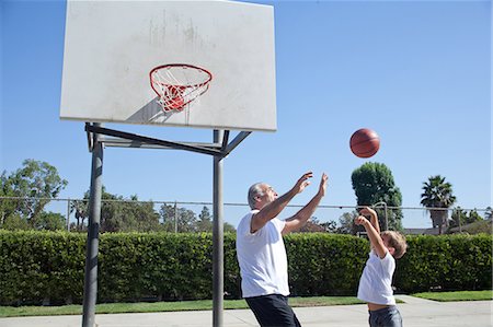role model (male) - Man and grandson playing basketball Stock Photo - Premium Royalty-Free, Code: 614-07146502