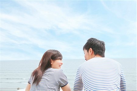 simsearch:614-06896801,k - Rear view of couple at coast, face to face and laughing Stock Photo - Premium Royalty-Free, Code: 614-07194475