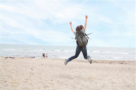 simsearch:614-07194495,k - Rear view of woman jumping on beach Stock Photo - Premium Royalty-Free, Code: 614-07194477
