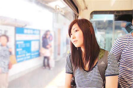 Young woman on train, looking through window Stock Photo - Premium Royalty-Free, Code: 614-07194471