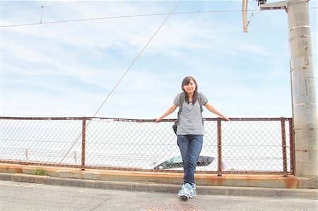 simsearch:614-07194495,k - Young woman leaning against fence Stock Photo - Premium Royalty-Free, Code: 614-07194472