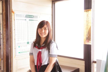 Woman wearing school uniform at train station Stock Photo - Premium Royalty-Free, Code: 614-07194486