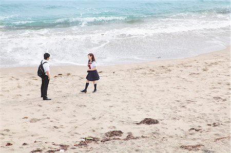 pictures of women in school uniforms - Young couple on sandy beach Stock Photo - Premium Royalty-Free, Code: 614-07194494