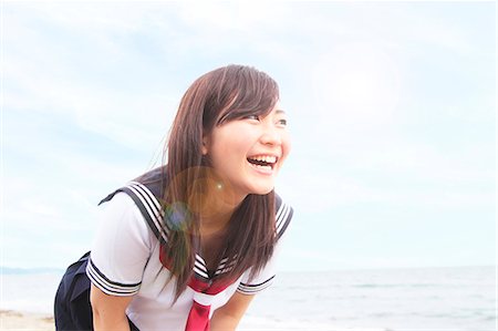 simsearch:614-07194495,k - Young woman leaning forwards laughing Stock Photo - Premium Royalty-Free, Code: 614-07194498