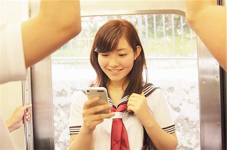 simsearch:614-07194495,k - Young woman standing on train using smartphone Stock Photo - Premium Royalty-Free, Code: 614-07194508