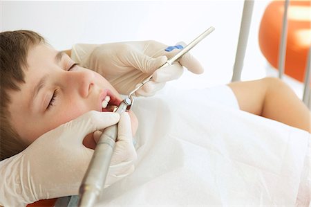 simsearch:649-07063859,k - Boy patient receiving dental treatment Stock Photo - Premium Royalty-Free, Code: 614-07194609