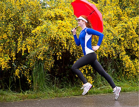 sport girl - Teenage girl jogging with umbrella on road, Bainbridge Island, Washington, USA Stock Photo - Premium Royalty-Free, Code: 614-07194650