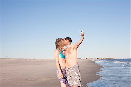 simsearch:614-06896801,k - Couple taking self portrait on beach, Breezy Point, Queens, New York, USA Stock Photo - Premium Royalty-Free, Code: 614-07234835