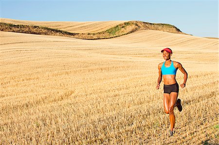 sports outdoor autumn - Young woman running across field, Bainbridge Island, Washington State, USA Stock Photo - Premium Royalty-Free, Code: 614-07234910